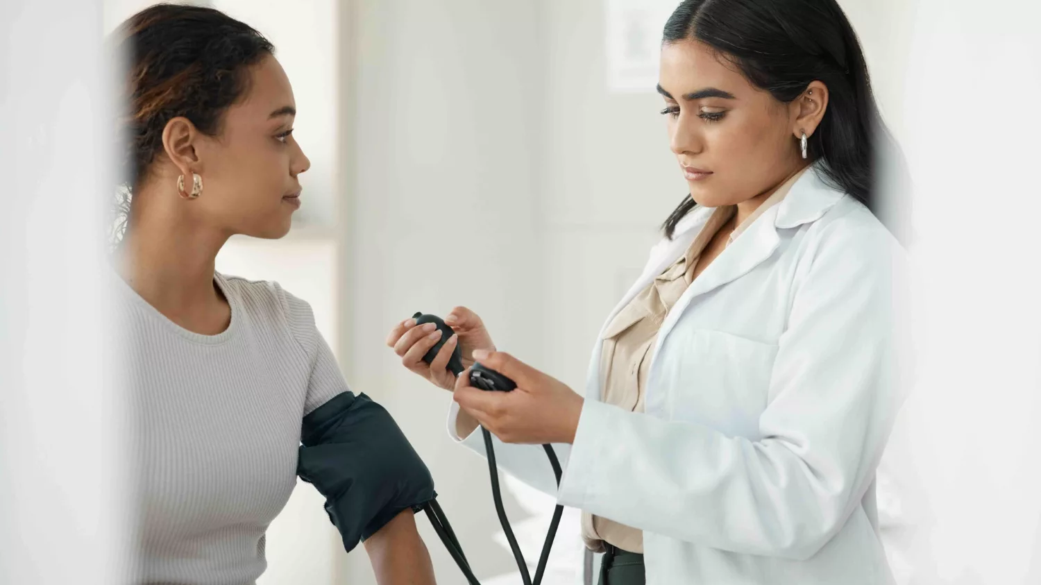 Woman at a health center taking blood pressure