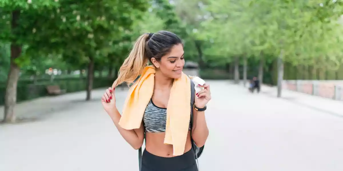 Woman eating after a workout in an outdoor park