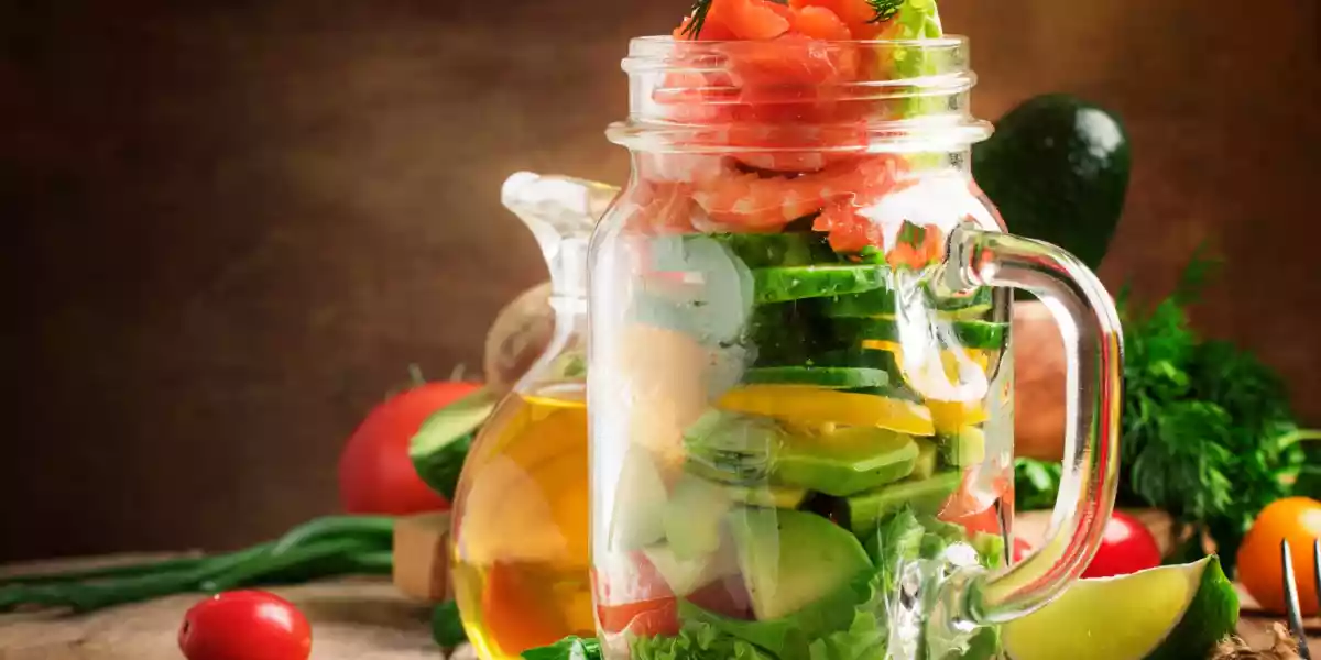 Salad with vegetables avocado shrimp and trout and sunflower oil source of omega 3
