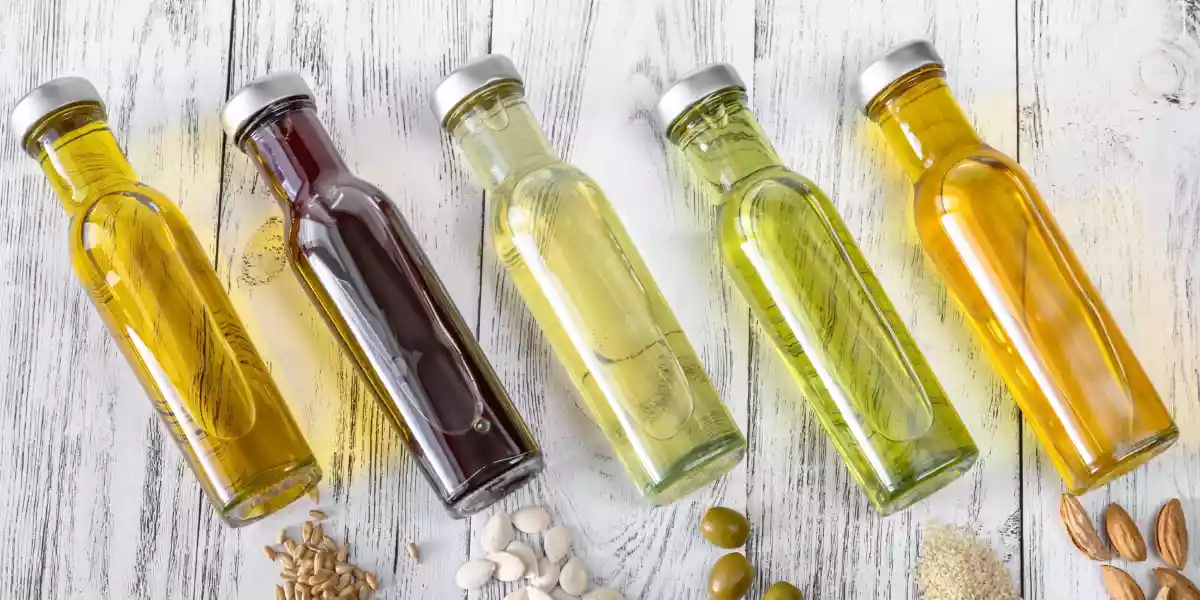 Assortment of vegetable oils and their respective seeds and fruits of origin