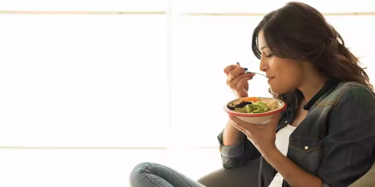 Woman eating a healthy bowl of superfoods